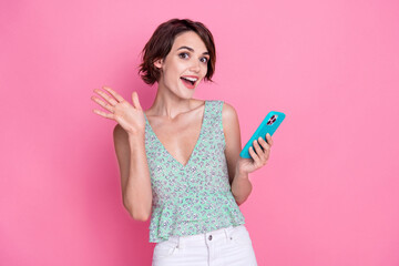 Photo of beautiful nice young pretty girl brown hair cyan top surprised hold phone eshop ad black friday isolated on pink color background