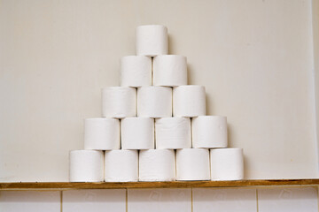 White toilet paper on a bathroom shelf.