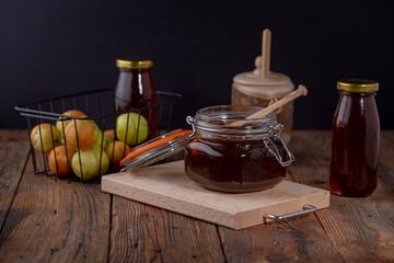 Honey dripping from honey dipper in wooden bowl. Close-up. Healthy organic Thick honey dipping from...