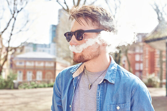 Teenage boy smoking in park