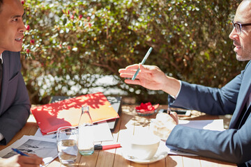 Businessmen in meeting at cafe