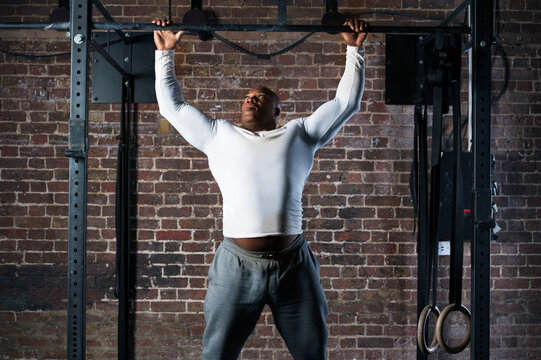 Mid adult man doing pull-ups