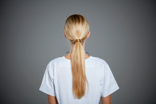 Rear view of young woman with ponytail.
