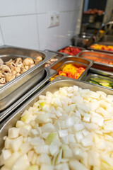 Stainless steel food trays on counter in professional kitchen