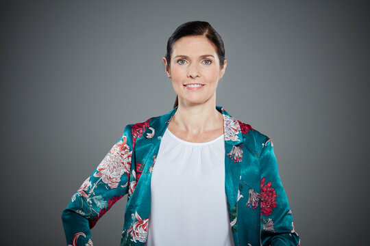 Portrait of mid adult woman wearing floral pattern jacket.