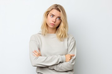 Portrait of troubled and annoyed blond girl tired of listening same old lies and excuses leaning on palm and staring skeptical with bothered bored expression standing white background