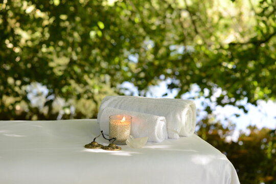 Candle and towels on massage table