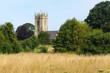 Fototapeta na wymiar View across summer grass of historic St Mary the Virgin Church Shawbury