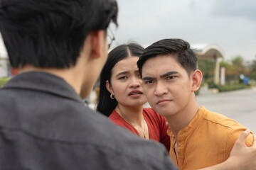 An irate and protective young asian man threatens an obsessed guy stalking his wife to stay away.