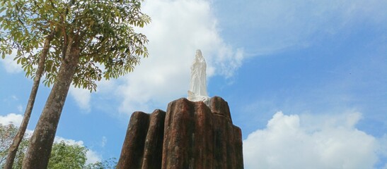 Air upas - August 9, 2023: Mother Maria's statue on a stone in the Air Upas Village, Air Upas District, Ketapang Regency, West Kalimantan, Indonesia - obrazy, fototapety, plakaty
