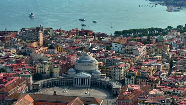 A view of Napoli, Italy, Aerial view of the historic center, panoramic drone view of the entire city of Italy. Flight over historical landmarks, narrow streets and buildings with colour rooftops