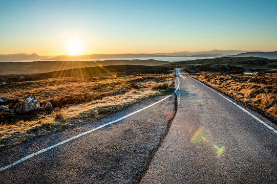Sunrise over highway at Bealach na Ba in Scotland