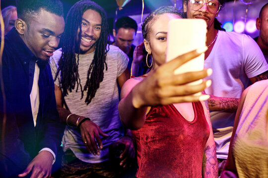 Friends taking selfie at nightclub