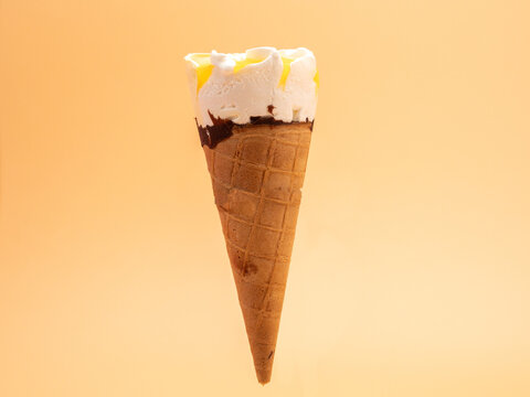 Lemon ice cream waffle cups. Ice cream on an orange background.