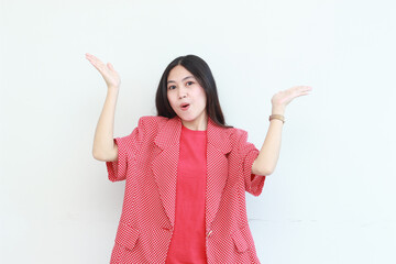 portrait of beautiful asian woman wearing red outfit pointing up for copy space with smiling gesture