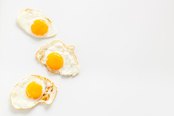 Fried eggs pattern on white background, top view. Breakfast concept