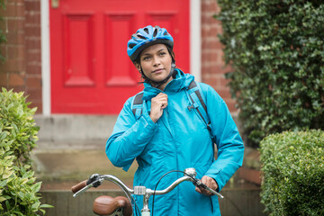 Woman in blue jacket commuting by bicycle