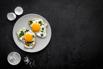 Cooking fast breakfast with fried eggs, top view. Food background