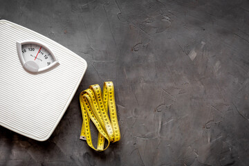 White floor weight scales with measuring tape. Body weight control and slimming concept