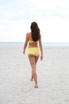 Woman in yellow bikini at beach
