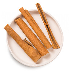 Cinnamon stick in a white bowl isolated