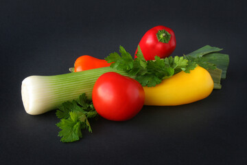 Fresh vegetables on a black background, close-up, copy space