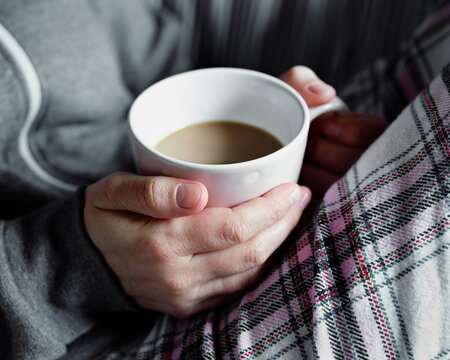 Woman's hand holding cup of tea