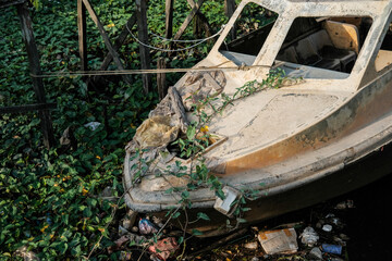 wreck of a fast boat dumped on the river bank, old rusty boat, old abandoned boat, abandoned speed boat, old boat wreck, old boat in the woods, speed boat