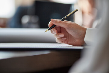 Hand of businesswoman signing document