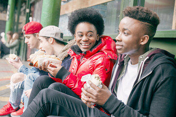 Teenage friends eating fast food