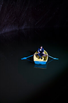 Young man in rowboat on lake