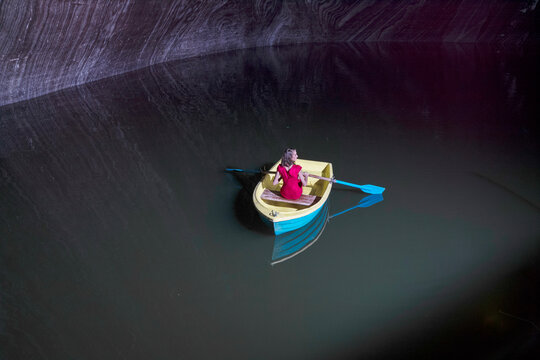 Young woman in rowboat on lake