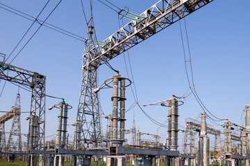 A high-voltage power electrical substation. Power lines, poles, ceramic and glass insulators,...
