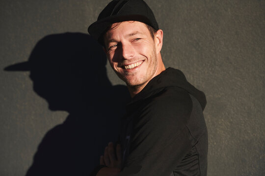 Portrait of man wearing baseball cap smiling