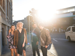 Friends walking along street together