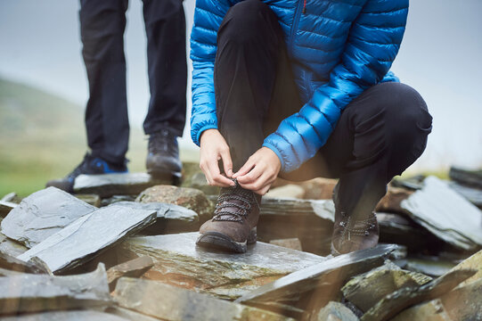 Man tying shoelace on scree