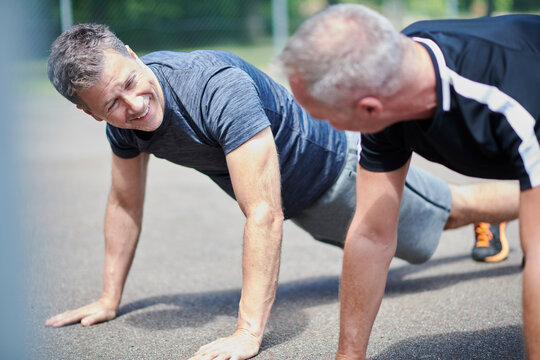 Mature men doing push-ups