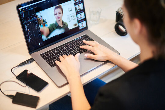 Woman editing photograph on laptop
