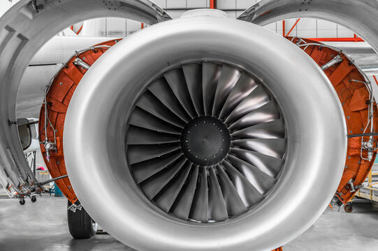 Open airplane engine in hangar