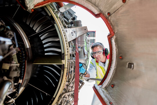 Man working on airplane engine