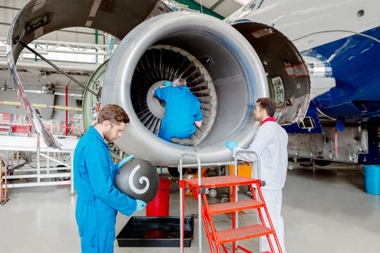 Men working on airplane engine