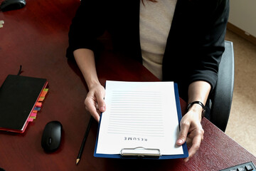 A close-up of employers or recruiters considering candidates' resumes, interviews, the concept of...