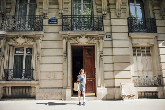 Young woman outside building in Paris, France