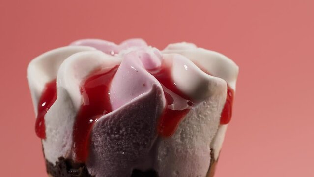 Strawberry ice cream in waffle cups. Ice cream on a pink background.