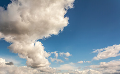 Naklejka na ściany i meble Blue sky clouds background. Beautiful landscape with clouds and orange sun on sky