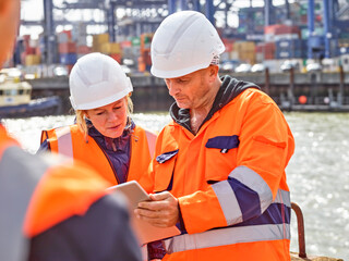 Dock workers with digital tablet at Port of Felixstowe, England