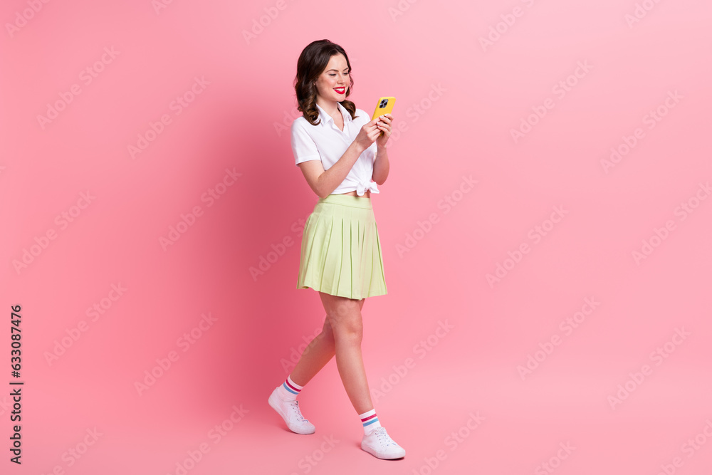 Sticker full length photo of pretty cute young girl dressed white top chatting modern gadget walking isolate