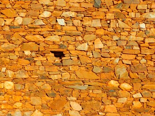 background ancient wall of red rocks in a ancient village