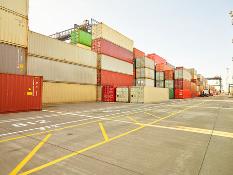 Stacks of cargo containers on concrete, Felixstowe, England.