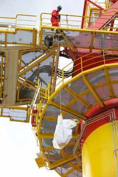 Worker sending down package from platform
